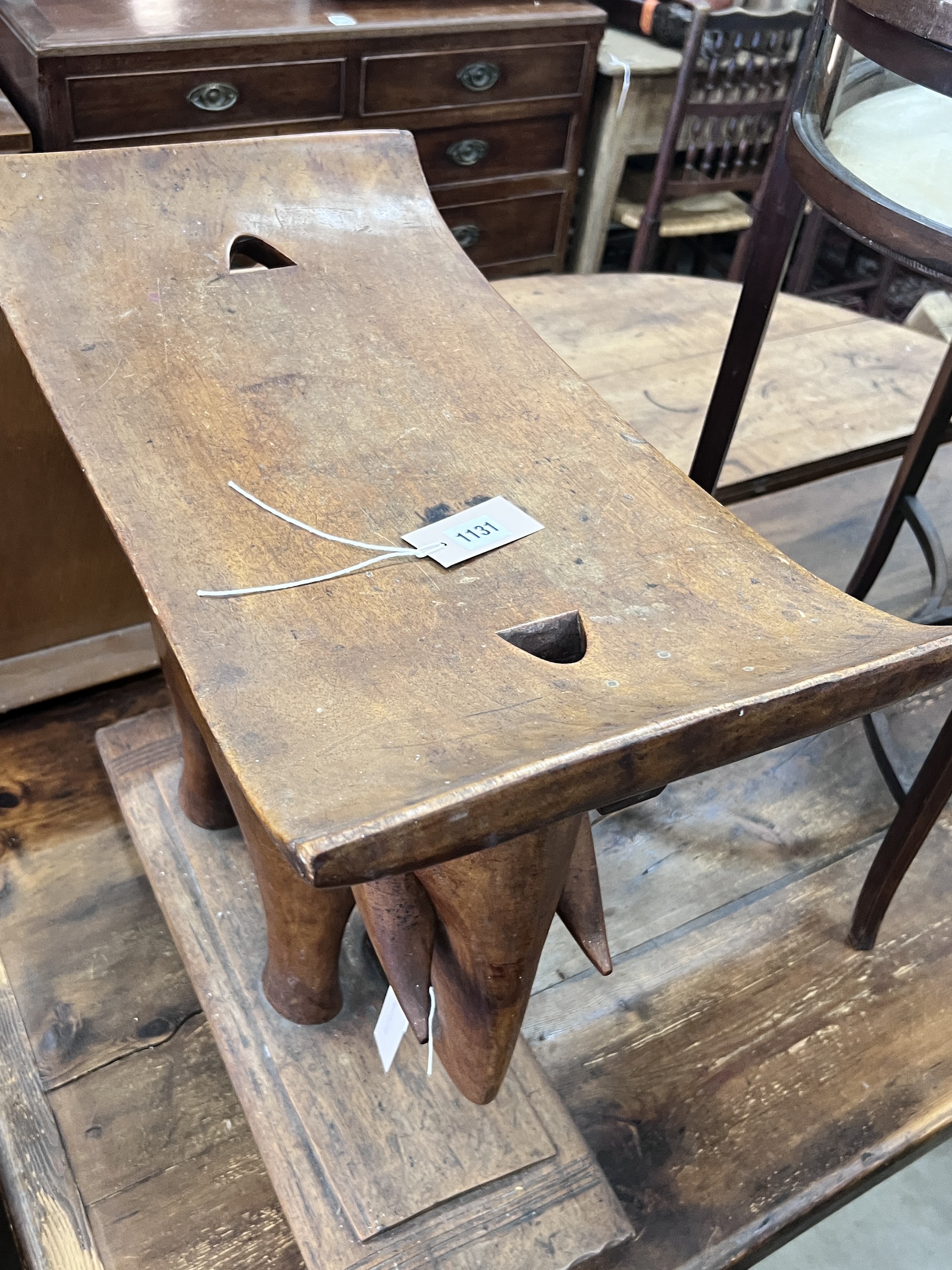 An African Ashanti style carved hardwood elephant stool, width 59cm, depth 32cm, height 58cm
